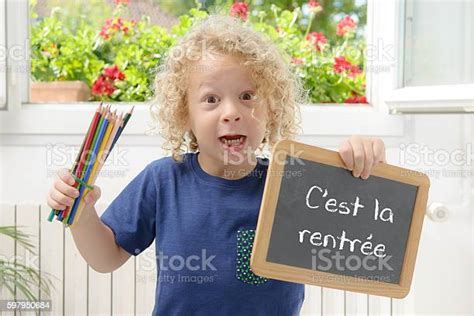 Boy Holding A Slate Written Back To School Stock Photo Download Image