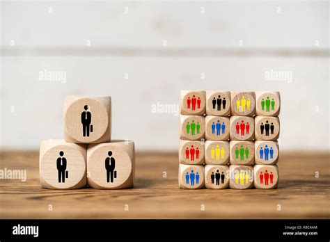 few big clients vs many small clients symbolized with cubes on wooden background Stock Photo - Alamy