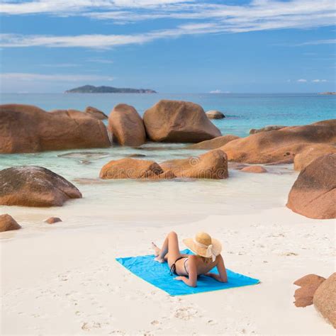 Woman Sunbathing At Anse Lazio Picture Perfect Beach On Praslin Island