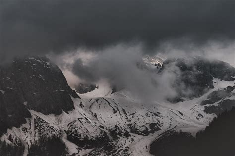 Black Mountain Covered by Snow Near Water · Free Stock Photo