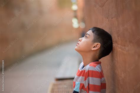 Little boy sitting alone with sad feeling Stock Photo | Adobe Stock