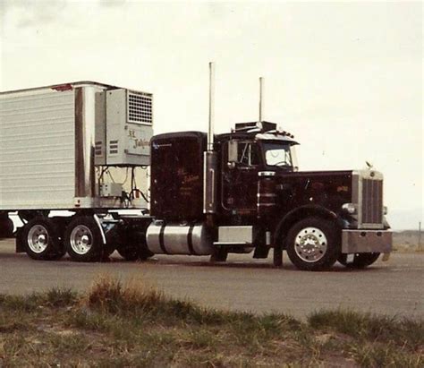 A Semi Truck With A Trailer On The Road