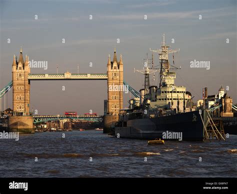 Hms Belfast At Her London Berth With Tower Bridge In The Background