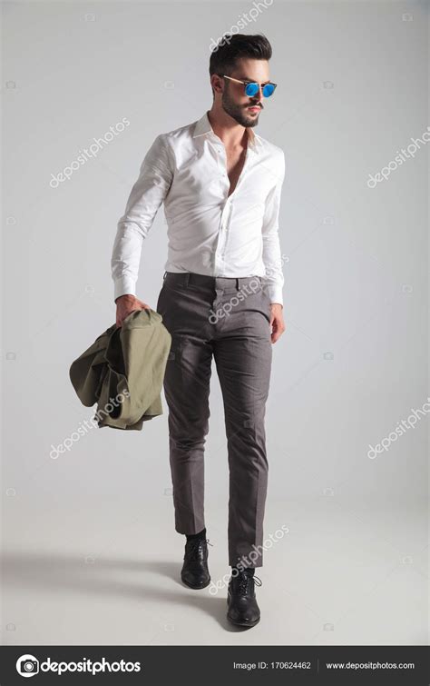 Fashion Man Holding His Jacket And Walking Stock Photo Feedough