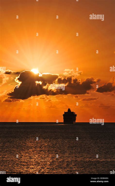 Cruise Ship Sailing Into The Sunset With Sunburst Effect Stock Photo