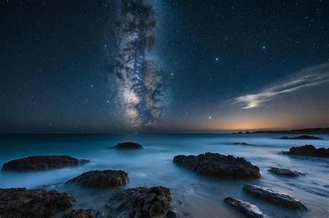 Premium Photo | A night sky with stars and a starry sky above the ocean