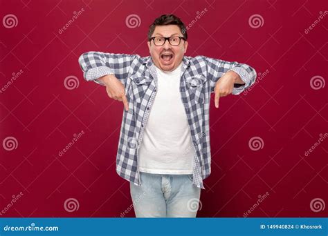 Portrait Of Amazed Handsome Middle Aged Man In Checkered Shirt