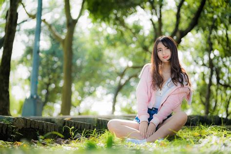 4K Asian Grass Bokeh Brown Haired Sitting Smile Hands HD