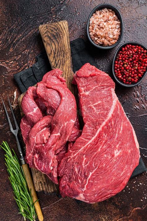 Raw Beef Meat Fillet Sliced On Wooden Cutting Board Dark Background