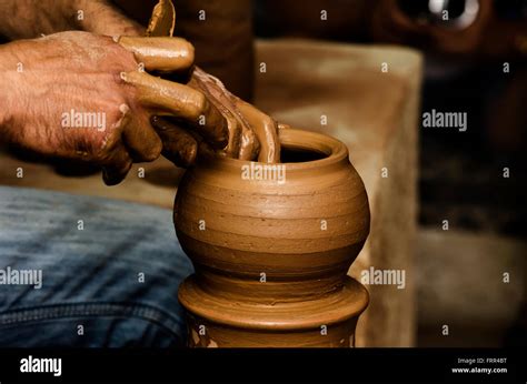 Potter Shaping Clay On The Pottery Wheel Stock Photo Alamy