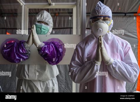 Los oficiales médicos saludan después de la muestra de esputo de un