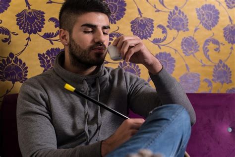 Premium Photo Man Smoking Shisha And Drinking Coffee