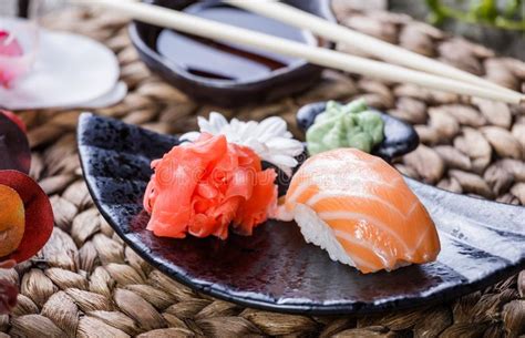 Sushi Set Nigiri And Sushi Rolls Decorated With Flowers On Bamboo