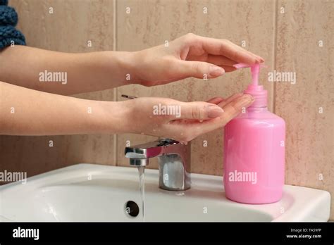 Woman Washing Hands With Liquid Soap In Bathroom Stock Photo Alamy