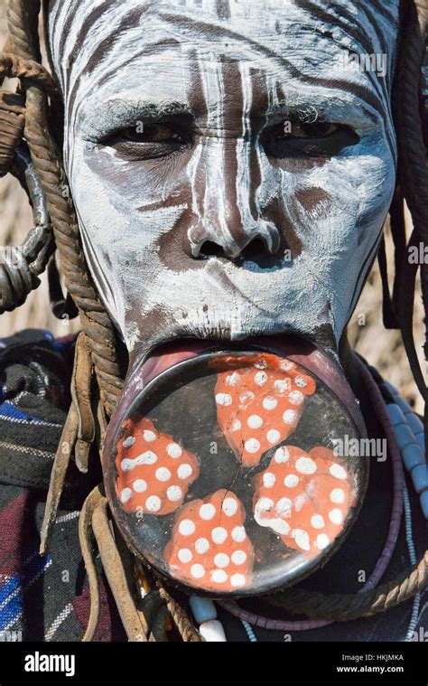 Mursi tribe people in traditional clothing with lip plate, Mursi ...