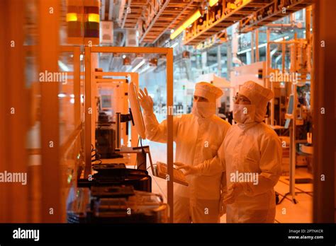 Dresden, Germany. 26th Apr, 2023. Employees of the Infineon chip group ...