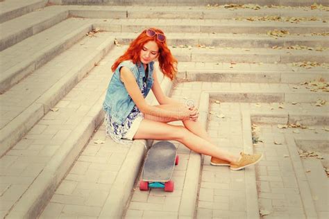 Redhead Women Sitting On Street Stairs Hear Her Skate Board Stock Image