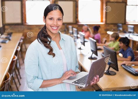 Pretty Teacher Using Laptop In Computer Class Stock Photo Image 50495064