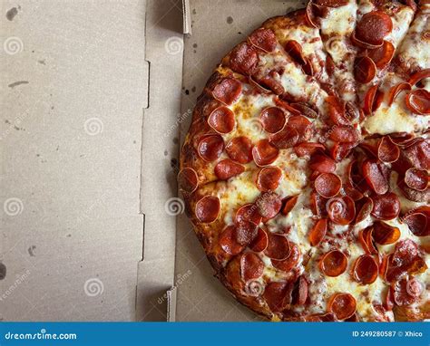 Large Pepperoni Pizza On Wooden Table Stock Photo