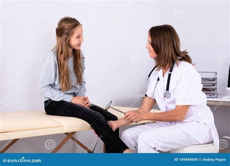 Doctor Checking Knee Reflexes of Patient with Reflex Hammer Stock Photo ...