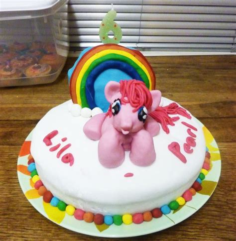 A Birthday Cake With A Pink Pony Sitting On Top Of It