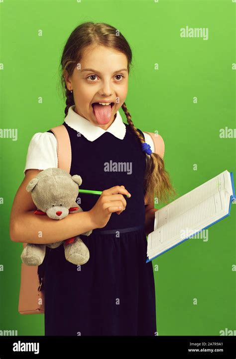 Girl Holds Teddy Bear And Open Notebook With Marker School Girl With