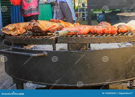 Traditional Asado Of A Whole Pork On A Typical Uruguayan Grill With