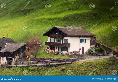 Countryside Valley View Of Swiss Alps With Traditional Swiss House At