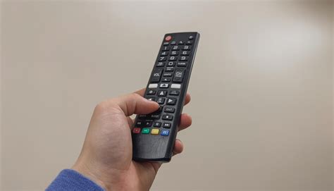 premium photo  person holding  remote control   number