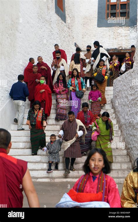 Young Women Men And Monks In Traditional Clothing In Punakha Dzong