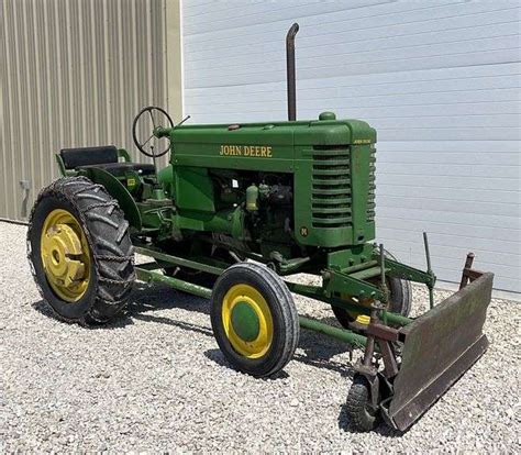 John Deere M tractor w/ snow plow - Schneider Auctioneers LLC