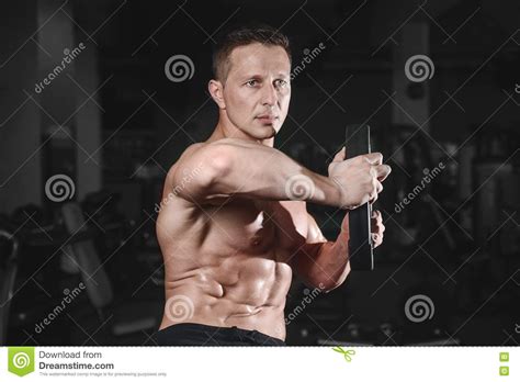 Handsome Muscular Bodybuilder Man Doing Exercises In Gym Stock Image