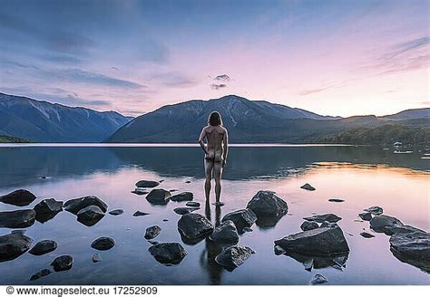 New Zealand New Zealand Tasman Rear View Of Naked Man Looking At Lake