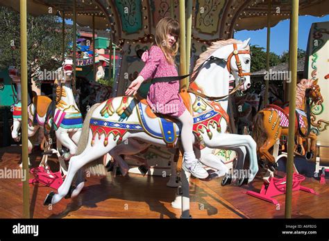 Young Girl Riding On Fairground Carousel Horse Downtown Disney