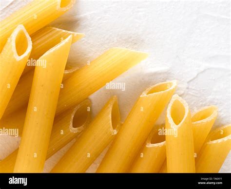 Raw Pasta As Food Background Italian Penne Rigate Macaroni Pasta On