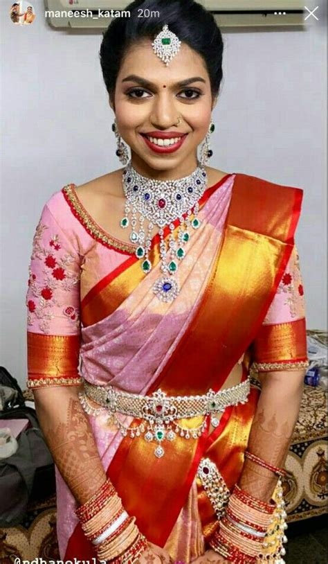 A Woman In A Pink And Gold Sari With Jewels On Her Head Smiling