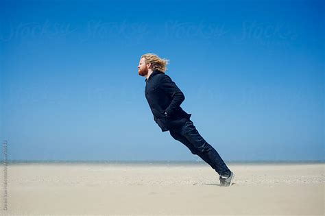 Young Man Ready For What Is Coming Leaning Into The Strong Wind On The