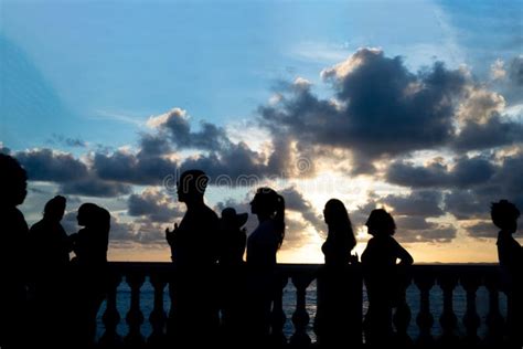 Silhouette Of Tourist People Enjoying The Sunset At Porto Da Barra In