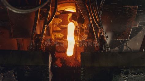 Molten Glass Pouring Out Of A Glass Melting Furnace In A Bottle Production Facility Glass