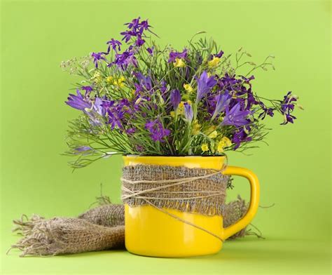 Premium Photo Beautiful Bouquet Of Wildflowers In Cup On Green Background