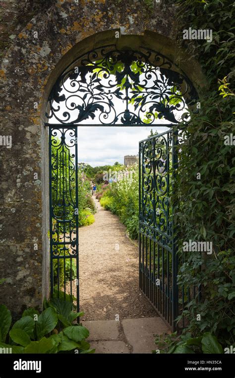 The Decorative Wrought Iron Gate And Cotswold Stone Archway Entrance