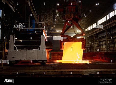 Steel Works - Crane delivers incandescent steel block to rolling mill ...