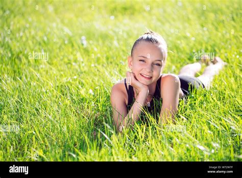 Cute Happy Little Girl Lying On The Grass Stock Photo Alamy