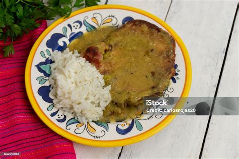 Mexican Smoked Pork Chops With Green Sauce And Rice On White Background