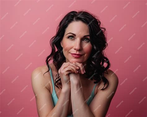 Premium Photo A Woman Posing For A Portrait On A Pink Background