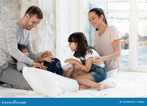 Happy Parents Playing Together with Small Adorable Kids. Stock Photo ...