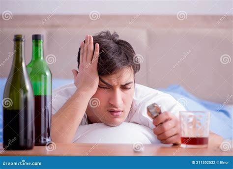 Man Alcoholic Drinking In Bed Going Through Break Up Depression Stock