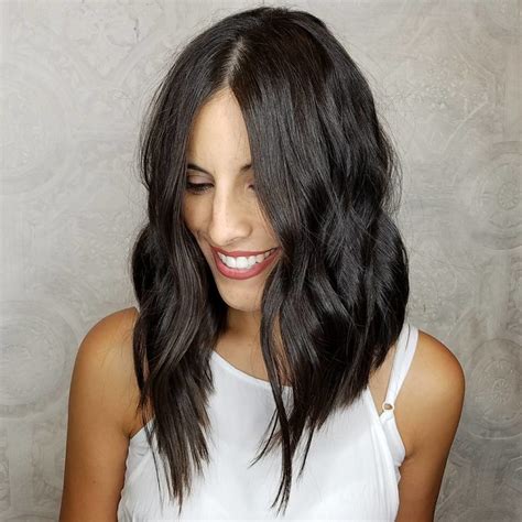 Chic Brunette Angled Wavy Layered Lob The Latest Hairstyles For Men And Women 2020