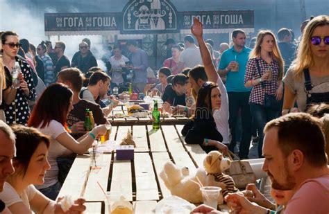 Crowd Of Hungry People Eating Meals Around Tables Outdoor During Street