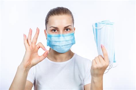 Premium Photo A Girl In A Protective Medical Mask Holds In Her Hands